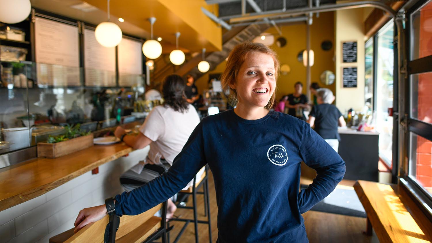 alumna standing inside downtown Raleigh restaurant